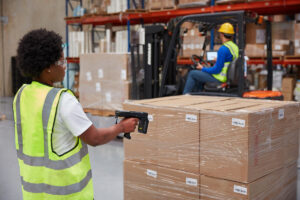 Warehouse worker scanning boxes with an RFID Scanner